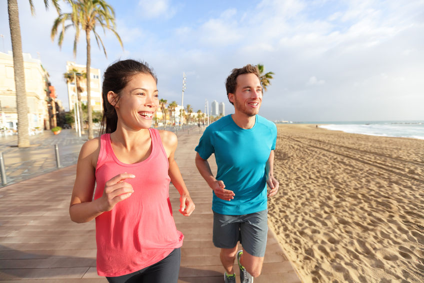 two people exercising on beach